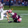A John Glenn player is being taken down by a Sheridan athlete.
