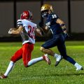 Symmes Valley is rushing with the ball as Notre Dame is trying to stop him