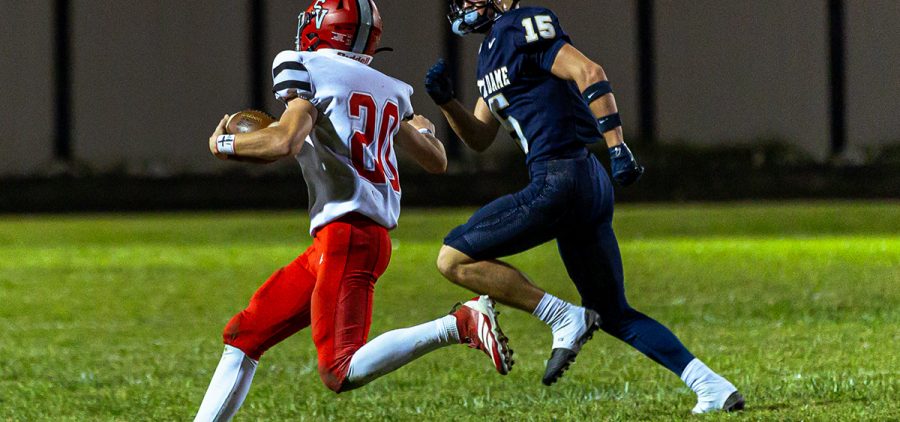 Symmes Valley is rushing with the ball as Notre Dame is trying to stop him