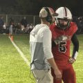 The Bishop Rosecrans' quarterback and coach meet to discuss the next play call.