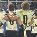 Miami Trace players line up and sing their fight song after the game against Washington.
