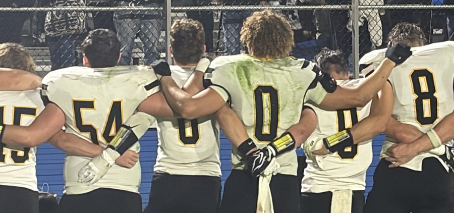 Miami Trace players line up and sing their fight song after the game against Washington.