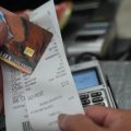 A SNAP recipient checks her balance left after purchasing food supplies with a California EBT card