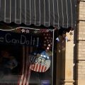 A storefront window in Wooster features a mannequin dressed up as Rosie the Riveter with the slogan on the window, "We can do it!" on Oct. 3, 2026, a reminder to patrons at Woosterfest, of the upcoming November elections.