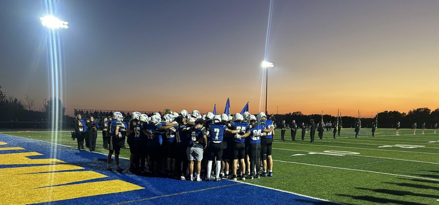 The Philo Electrics huddle up before their game against the Maysville Panthers.