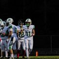 South Gallia defender stares down the Green offense breaking the huddle.