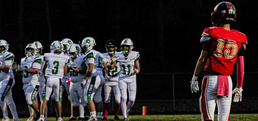South Gallia defender stares down the Green offense breaking the huddle.
