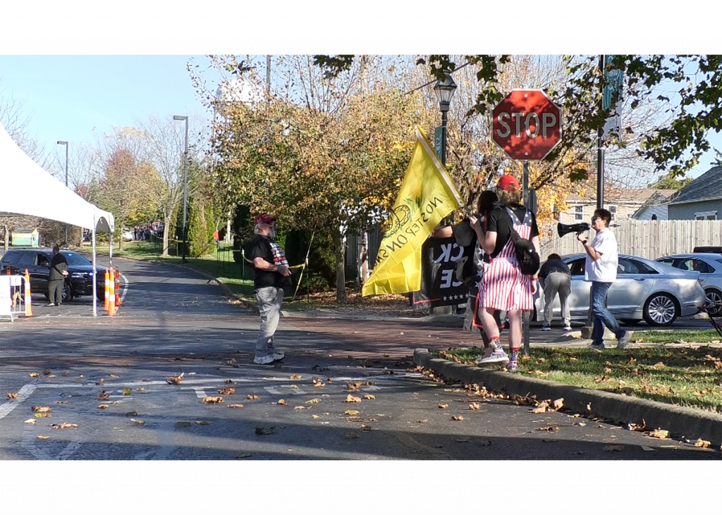 Protesters holding signs, flags and bull horns confront a Trump supporter that approached them. The Trump supporter had his phone out, recording the incident.