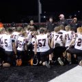 Versailles players huddled with their coach in white jerseys