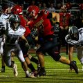 Worthington Christian player in a red jersey carrying the ball against vinton county player in white