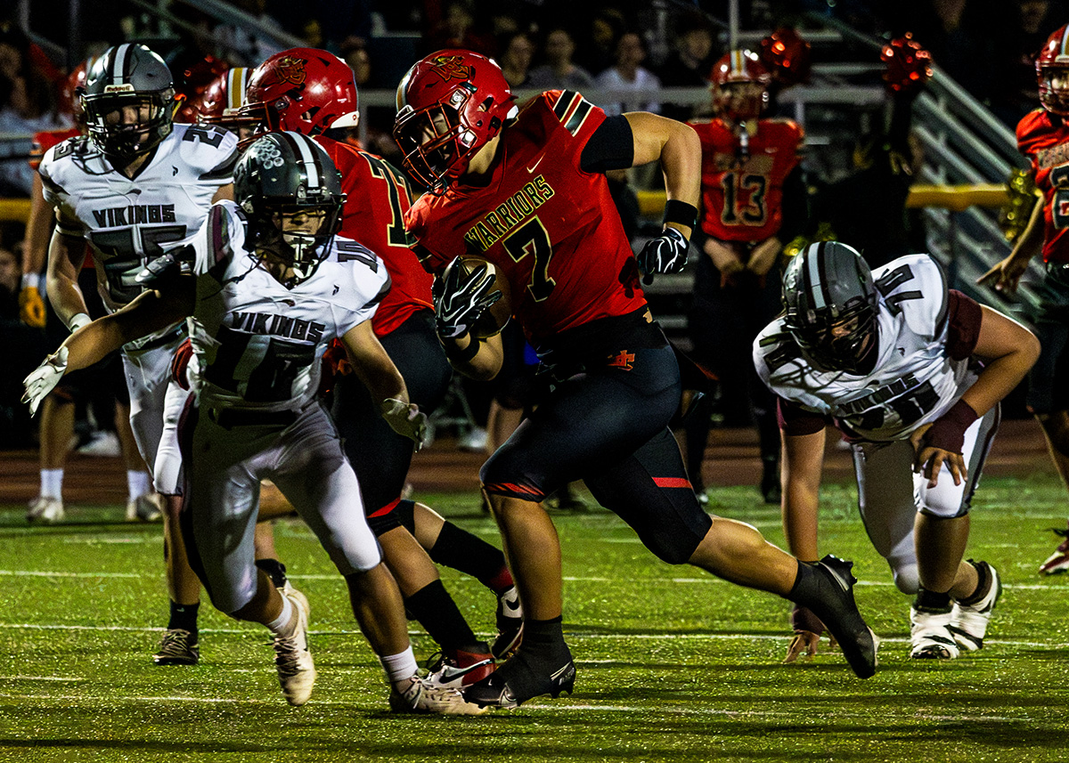 Worthington Christian player in a red jersey carrying the ball against vinton county player in white