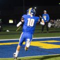 west muskingum player in a blue jersey running into the endzone