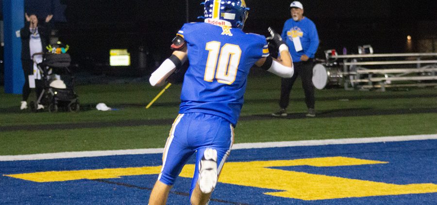 west muskingum player in a blue jersey running into the endzone
