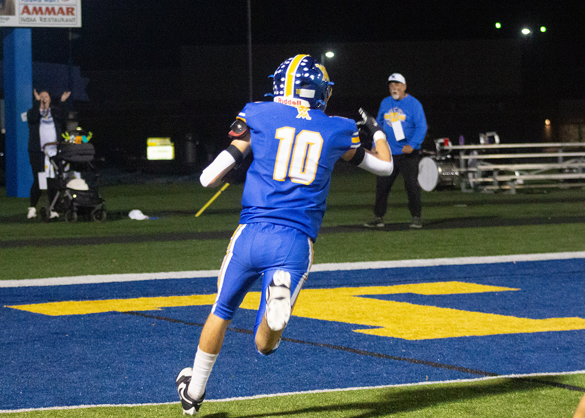west muskingum player in a blue jersey running into the endzone
